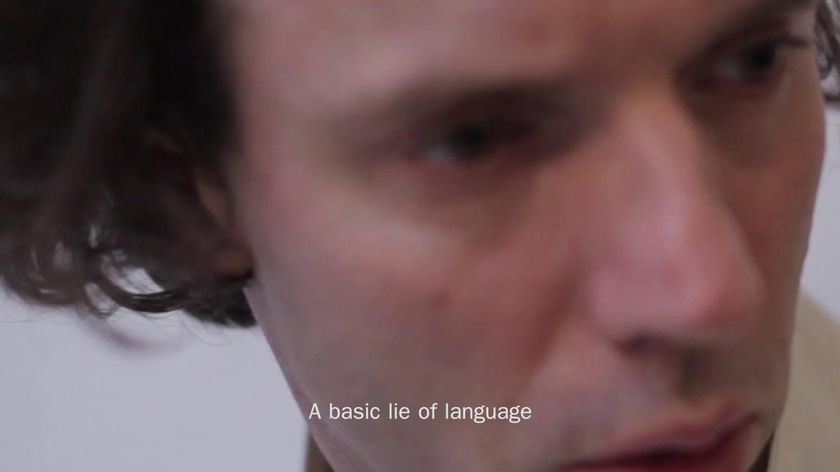 A close up of a face with text "A basic lie of language"